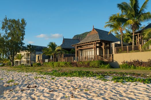 Beautiful bungalow at the beach with tropical plant around,sunny day at Mauritius island