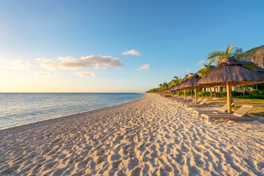 awesome beach at Mauritius island with wooden parasol in the right side, sunny day.