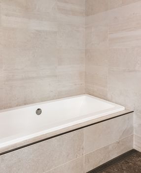 New bathroom with ceramic tile walls in beige tones. Contemporary design.