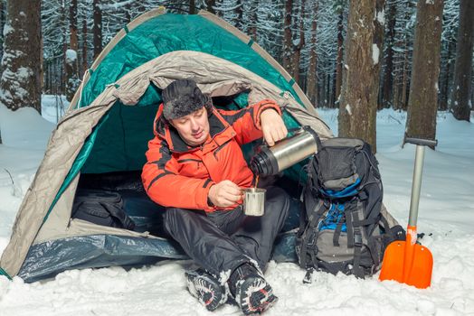 halt in a hike in the winter forest - a break for hot tea