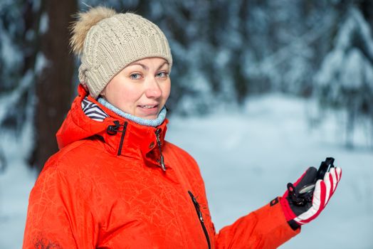 portrait of a beautiful girl in a winter forest with a compass