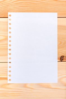 a sheet of paper on wooden boards - blank for writing