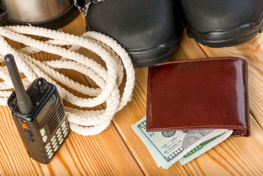 close-up objects - walkie-talkie, rope and money for travel