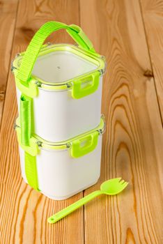 set of empty containers for food preservation with a fork on a wooden table