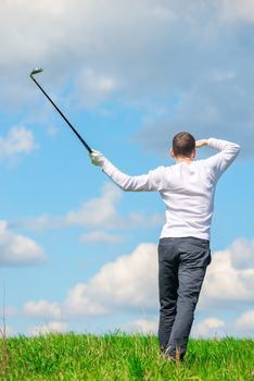 golfer after a blow looks into the field, looking for the ball