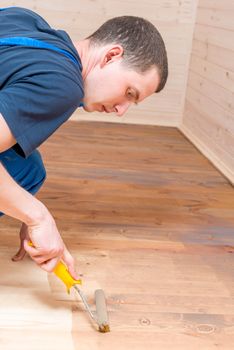 working roller paint on a wooden floor in the building