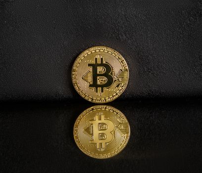 Bitcoin on a dark background with reflection