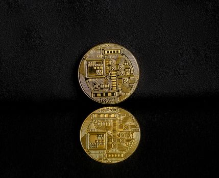 Bitcoin on a dark background with reflection