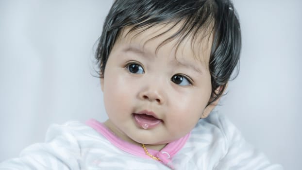 Asian cute baby girl lying on the bed