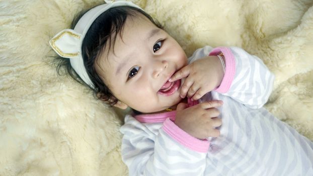 Asian cute baby girl lying on the bed