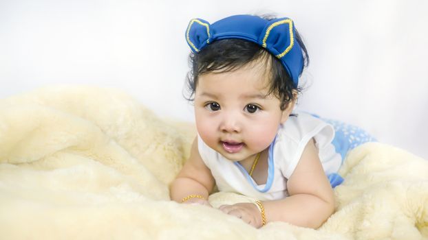 Asian Smiling baby girl crawling in bedroom