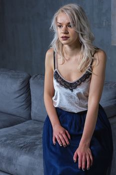 girl sitting on the couch. Room in loft style. Room with a fireplace