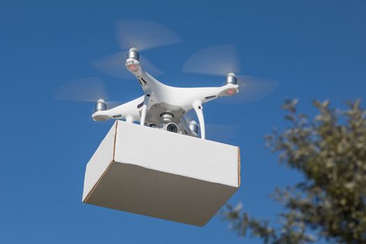 Unmanned Aircraft System (UAS) Quadcopter Drone Carrying Blank Package In The Air.