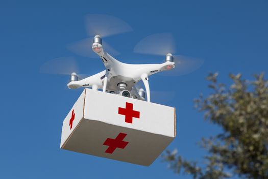 Unmanned Aircraft System (UAS) Quadcopter Drone Carrying First Aid Package In The Air.