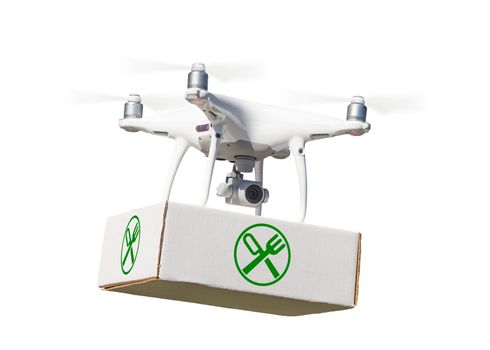 Unmanned Aircraft System (UAV) Quadcopter Drone Carrying Package With Food Symbol Label On White.