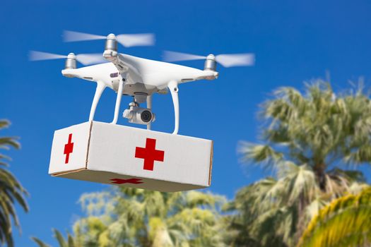Unmanned Aircraft System (UAS) Quadcopter Drone Carrying First Aid Package Over Tropical Terrain.