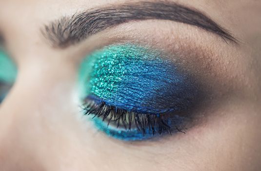 Turquoise glamour make-up of woman eye - macro shot