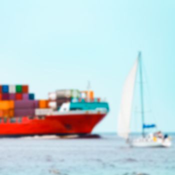 Red cargo ship - soft lens bokeh image. Defocused background