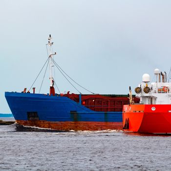 Merchandise import. Large blue cargo ship moving to Riga port