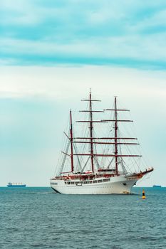 Big white sailing ship with three mast moving to the Riga port