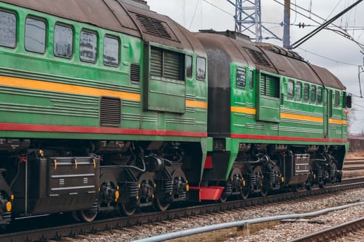 Green diesel cargo locomotive. Freight train in action