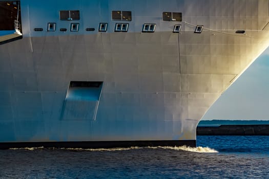 White giant brand new passenger ship moving in clear summer day