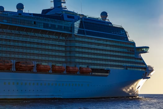 White giant brand new passenger ship moving in clear summer day