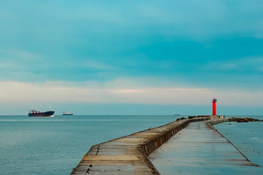 Merchandise import. Large blue cargo ship moving to Riga port