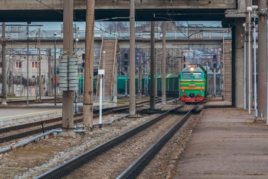 Green diesel cargo locomotive. Freight train in action