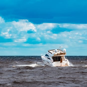 White speed boat moving fast to the Baltic sea. Water sport