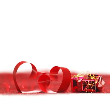 Valentines day ribbon hearts and gifts on decorative glitters, isolated on white