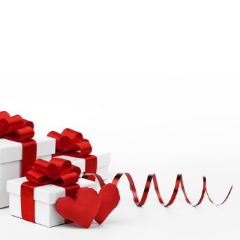 Valentines day gifts in white boxes with red ribbons and hearts isolated on white