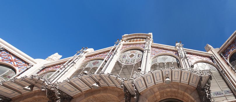 bottom view of the famous traditional central market hall in Valencia, Spain with decorated tile and glass
