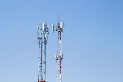 Mobile phone communication tower transmission  signal with blue sky background and antenna and twin