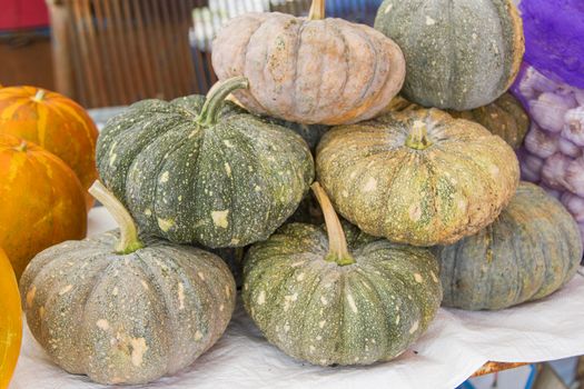 Many Thai pumpkins stack together.