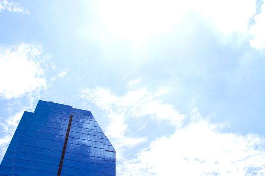 The building reflects with blue sky.