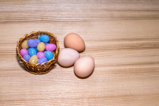 Easter eggs in a basket on a wooden background. Copy spase.
