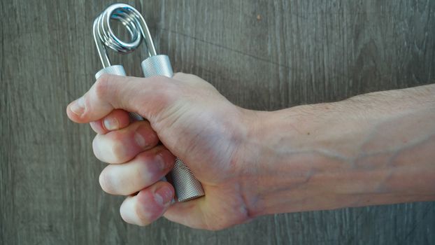 hand expander in the hand of a young athlete.