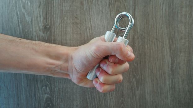 hand expander in the hand of a young athlete.