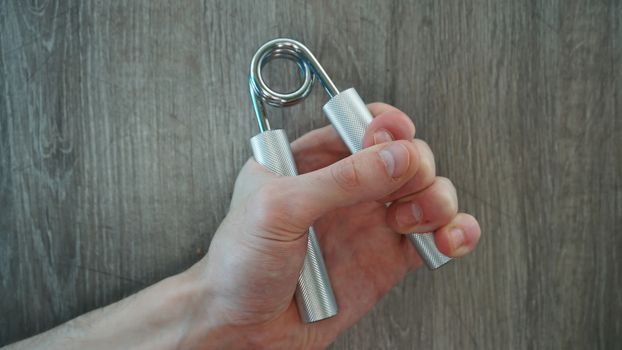 hand expander in the hand of a young athlete.