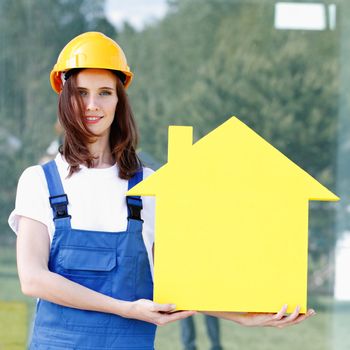 Forewoman presenting house symbol, construction concept