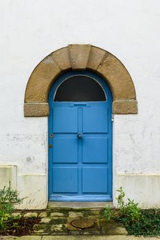 Old blue wooden door in Brittany, France