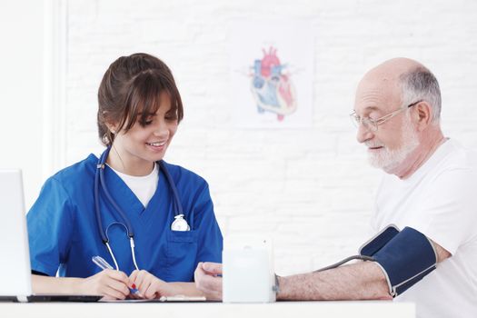 Doctor measuring blood pressure of male senior patient