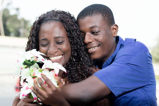 young woman is  very  happy to receive this beautiful flower.