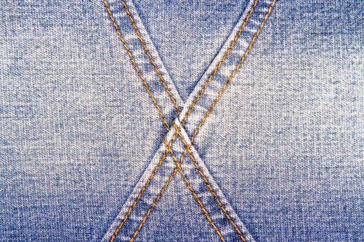 Blue jeans texture background and  cross orange seam 