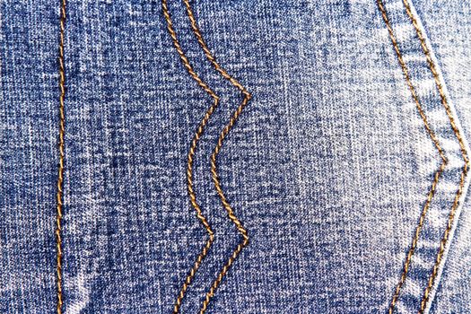 Blue jeans texture background and orange seam 