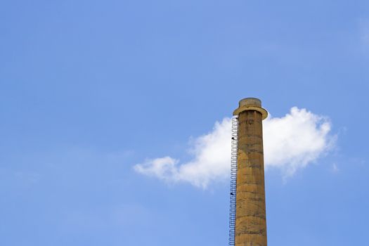 Chimney with cloud on blue sky