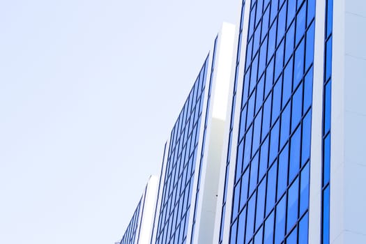 Blue sky reflected on blue building side