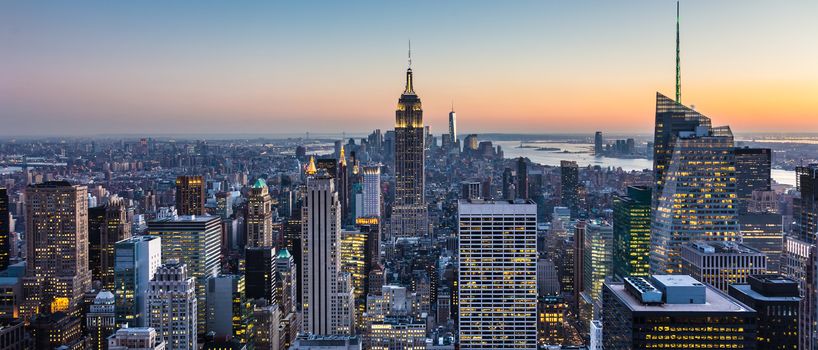 New York City. Manhattan downtown skyline with illuminated Empire State Building and skyscrapers at dusk. USA.