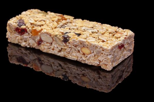 Granola bar with fruits and nuts on black background